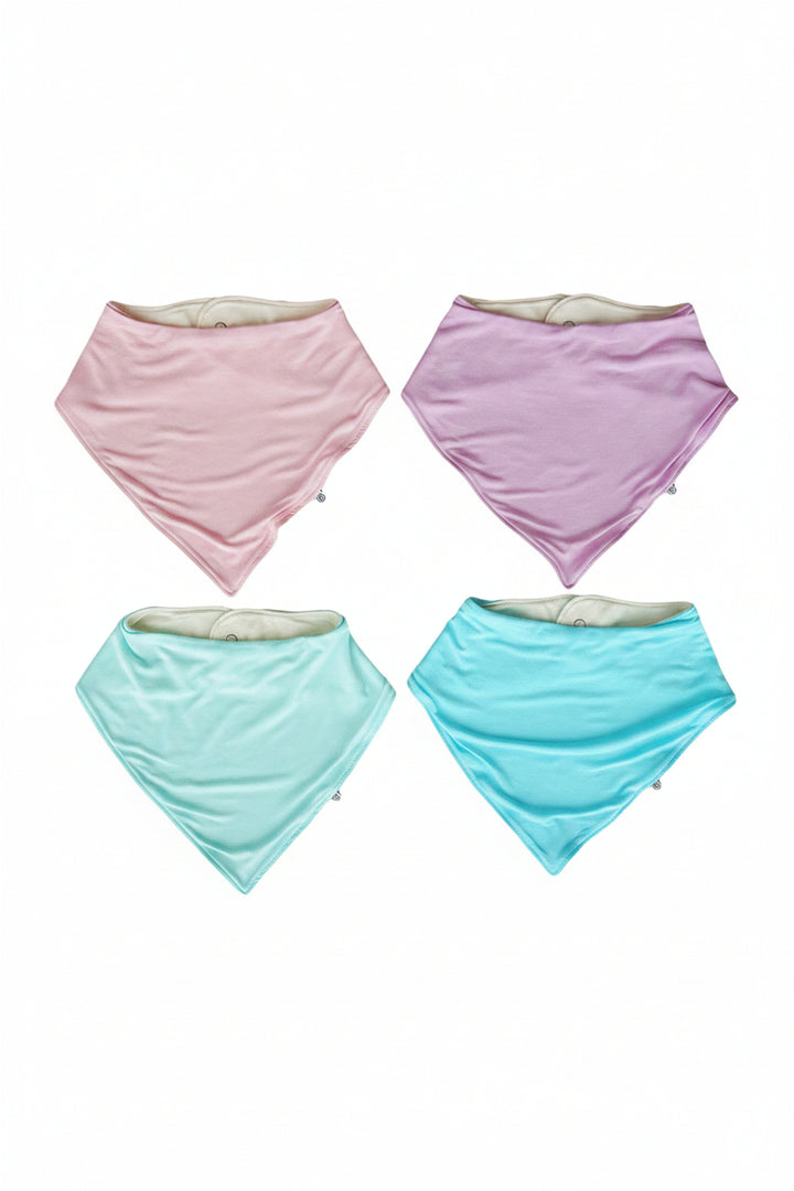 Four Caden Lane triangular bandana bibs in pastel pink, lavender, mint green, and turquoise on a white background. 