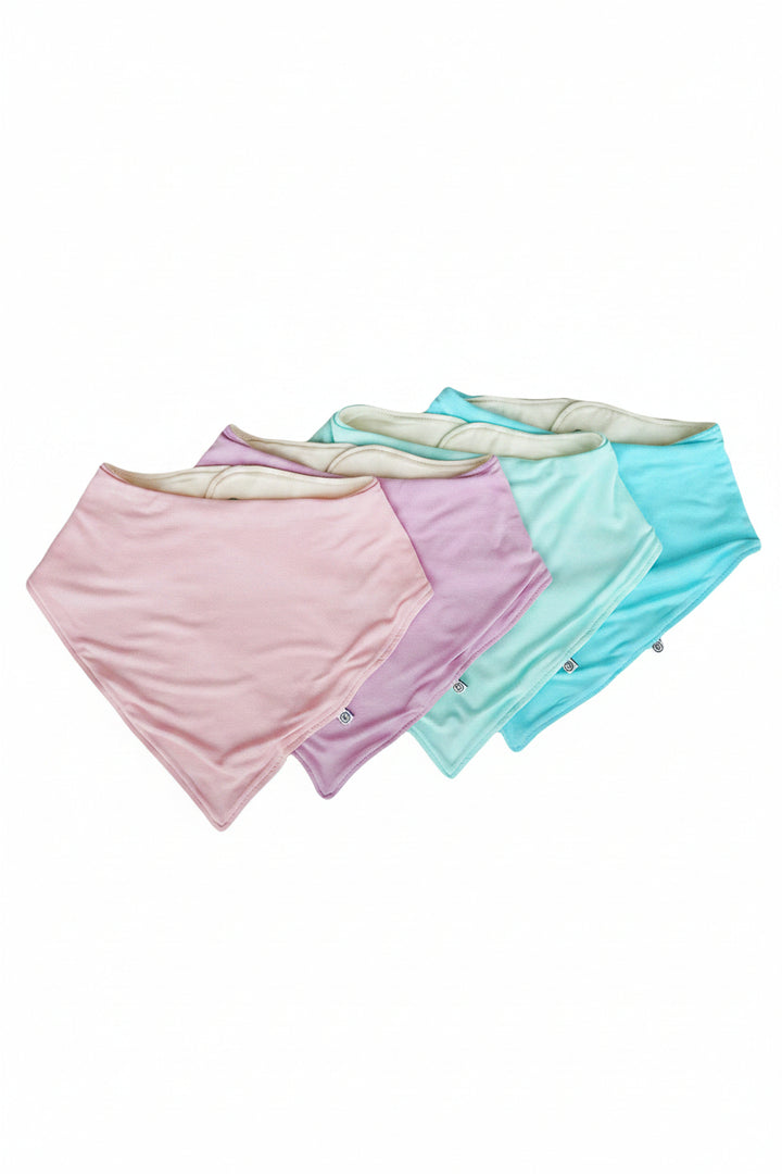 Four Caden Lane bandana-style baby burp cloths in pastel pink, lavender, mint green, and aqua blue, arranged  on a plain white background.