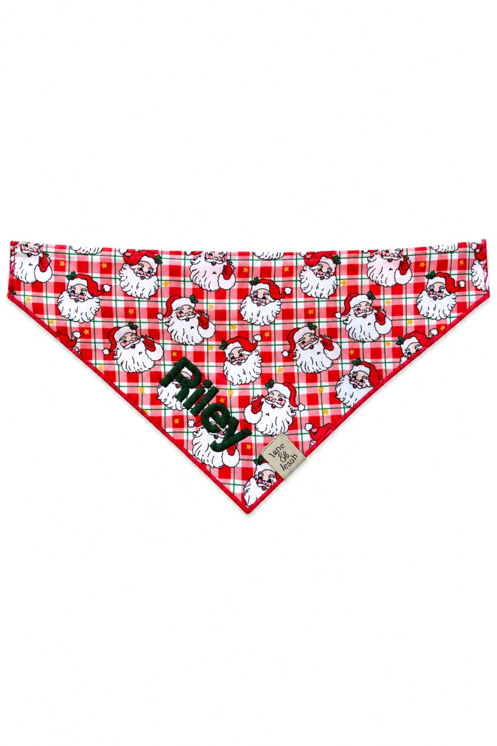 Lane & Leash personalized dog bandana in red plaid Cozy Claus print with vintage Santa Claus faces, tied bandana-style, embroidered with the name 'Riley' in green