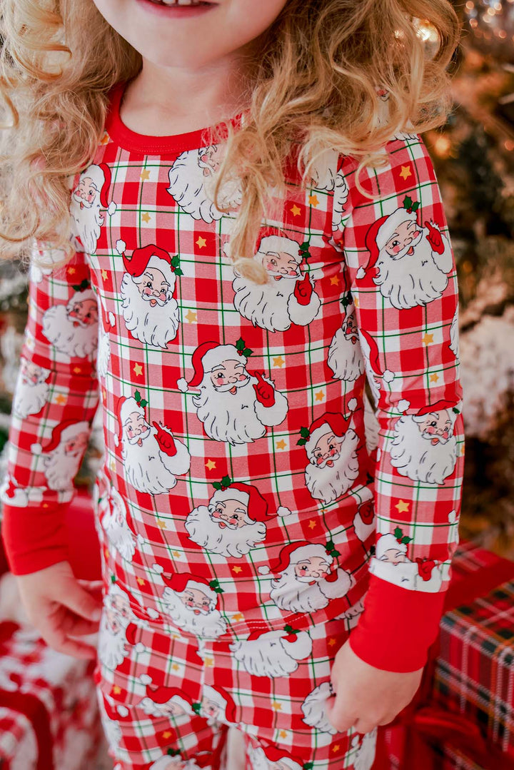 Close-up of the Caden Lane Cozy Claus kids' Christmas bamboo pajama set showcasing the festive vintage Santa plaid print and soft bamboo fabric.
