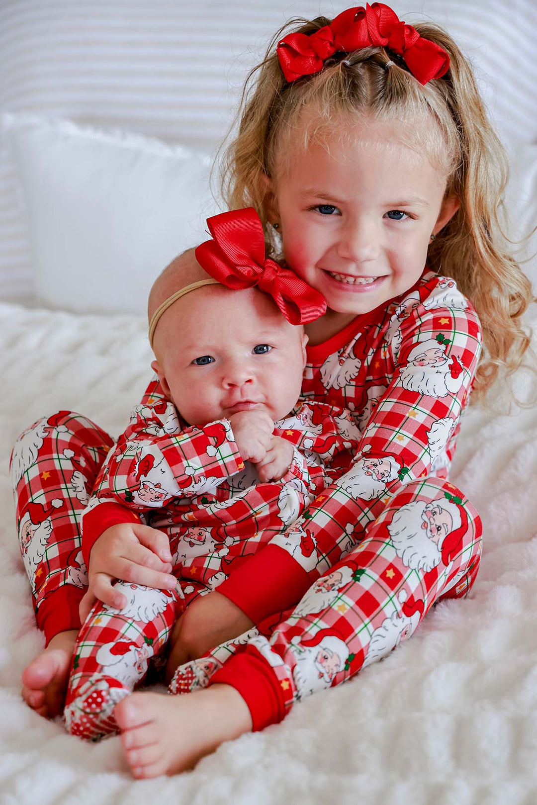 Siblings wearing Caden Lane Cozy Claus matching Christmas bamboo pajamas in a vintage Santa plaid print, perfect for holiday photos and cozy family traditions.