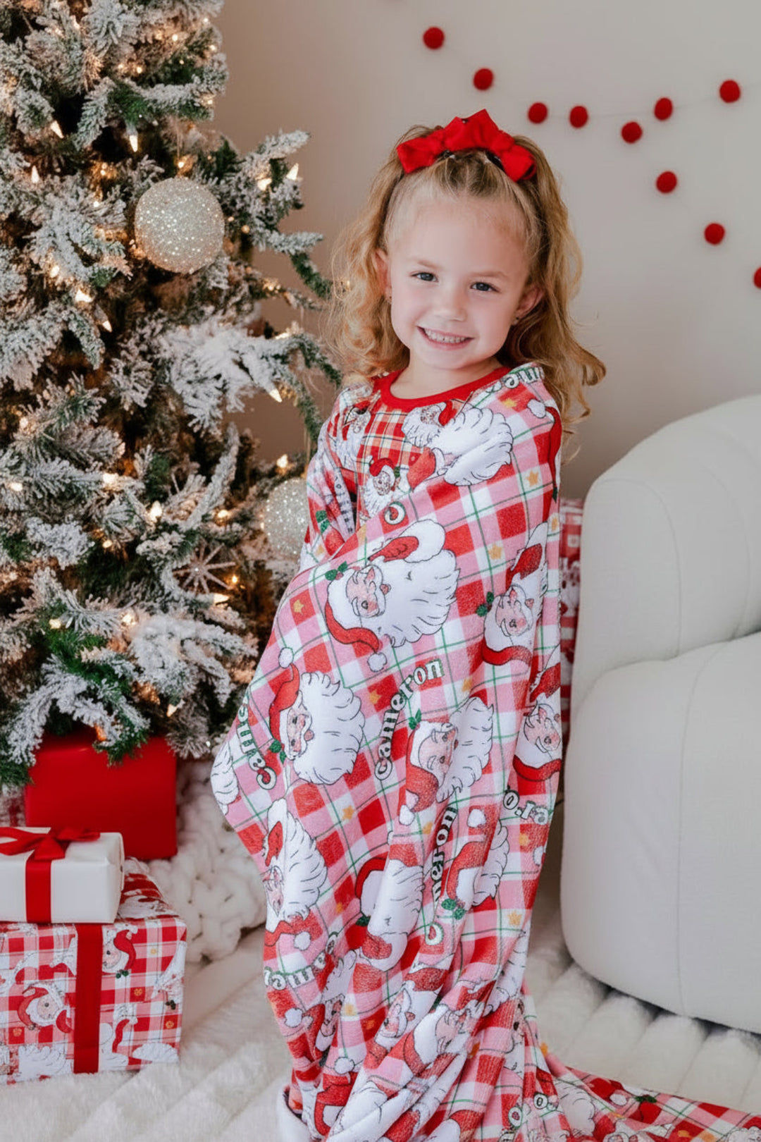 Little girl wrapped in a personalized Cozy Claus Christmas blanket with a vintage Santa print, perfect for cozy holiday moments, Christmas photos, and personalized Christmas gifts.