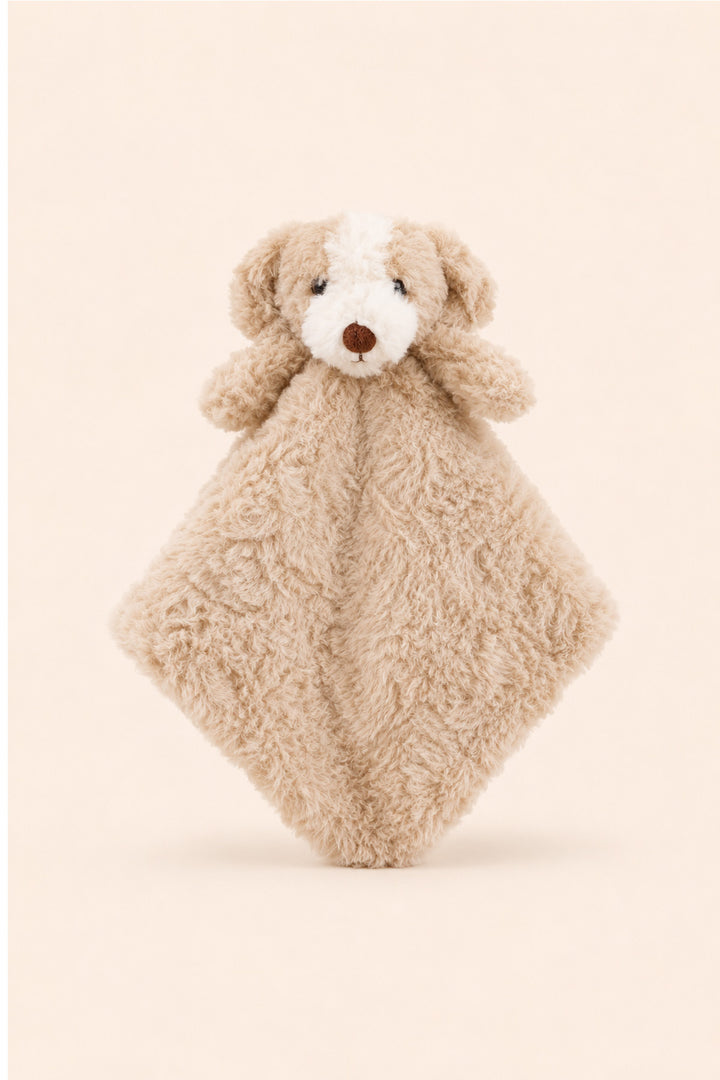 A Caden Lane plush puppy security blanket featuring a soft beige curly fur body, a white face patch, and a brown nose, set against a solid pale beige background.