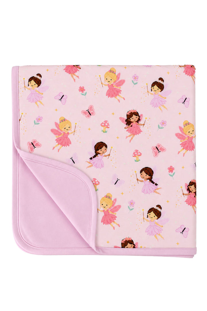 Folded Fairy Wishes glow-in-the-dark double-sided bamboo blanket with fairy print on one side and solid pink on the reverse