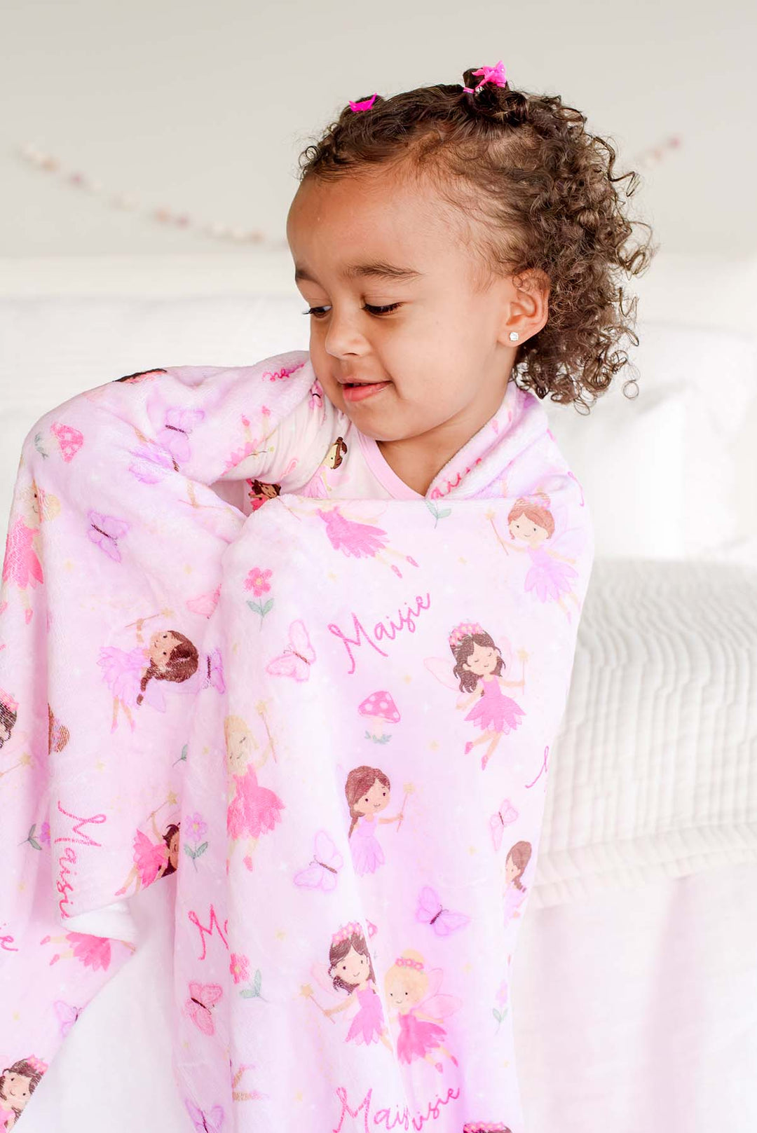 Toddler girl cuddled in the soft pink Fairy Wishes personalized kids&