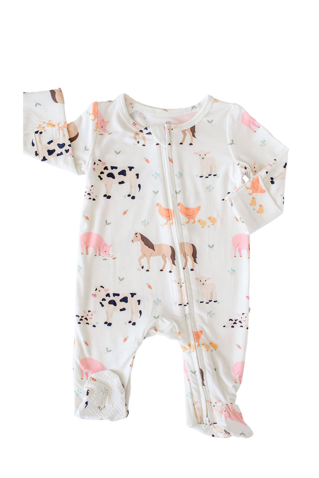 A Caden Lane baby footed sleeper with a front zipper, featuring an all-over farm animal print on a white background. The print includes pink pigs, black-and-white cows, brown horses, chickens, and carrots.