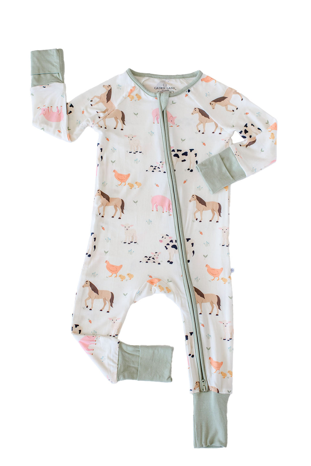 A Caden Lane baby long-sleeve footless zip-up sleeper with an allover farm animal print, featuring sage green cuffs and a matching green zipper, laid flat on a white background.
