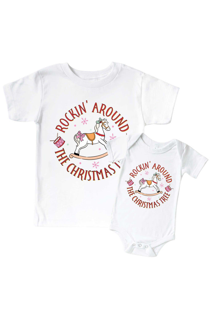 Caden Lane's matching "Rockin' Around the Christmas Tree" t-shirt and onesie featuring a pink rocking horse with drums and snowflakes, laid flat together for a sibling set.