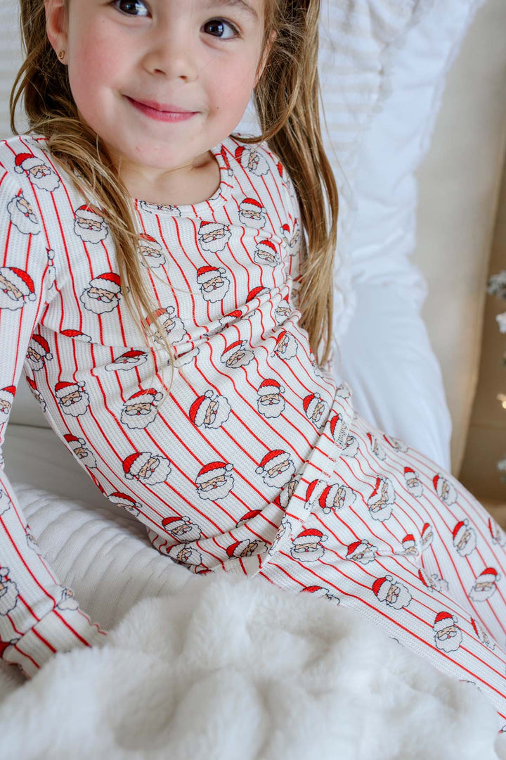 Caden Lane girls' bamboo Christmas pajama set in a playful Santa stripe print, featuring a long sleeve top and matching pants made from soft, breathable bamboo fabric.