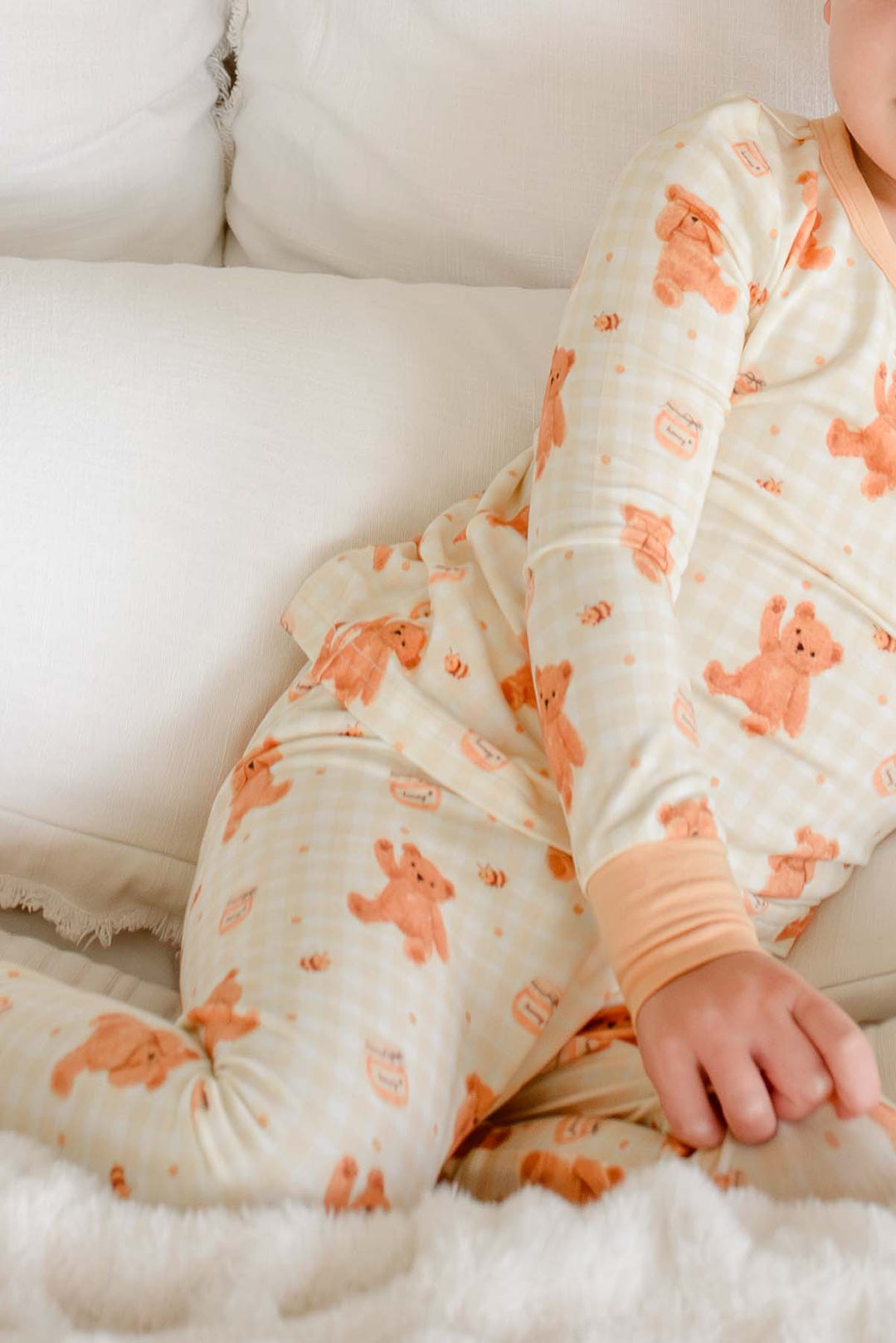 Toddler wearing a Caden Lane honey bear print two-piece pajama set