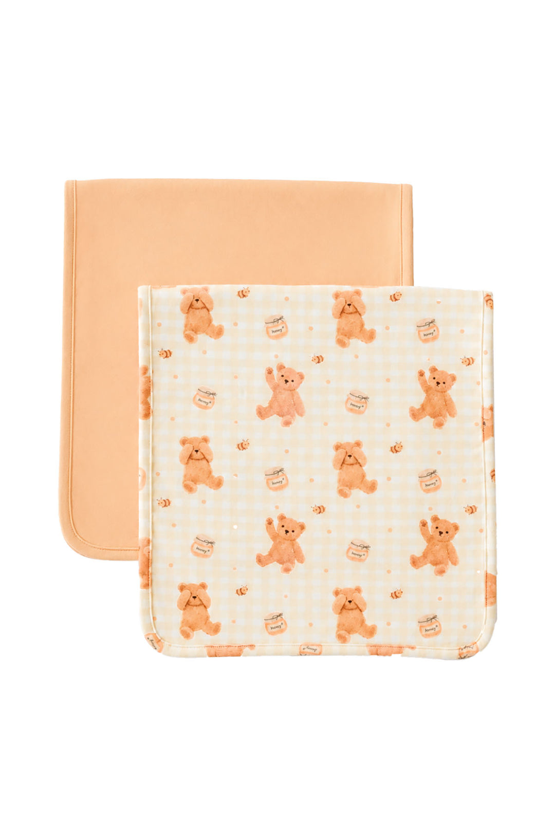 Set of two Caden Lane bandana burp cloths on a white background. One solid peach and one honey bear print with gingham and honey jar details