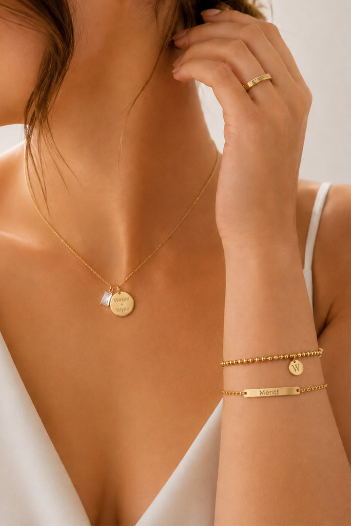 Caden Lane gold "Weslie + Wylie" necklace with birthstone charm, "grace" engraved ring, "Meritt" bar bracelet, and initial "W" disc bracelet