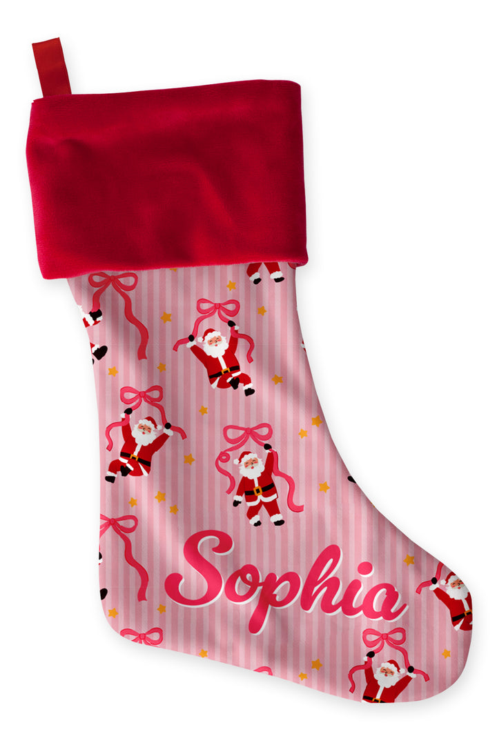 Caden Lane Personalized Name Christmas Stocking in the Jolly Ribbons print featuring a custom name, festive Santa and ribbon design, and coordinating family Christmas pajamas and holiday décor.
