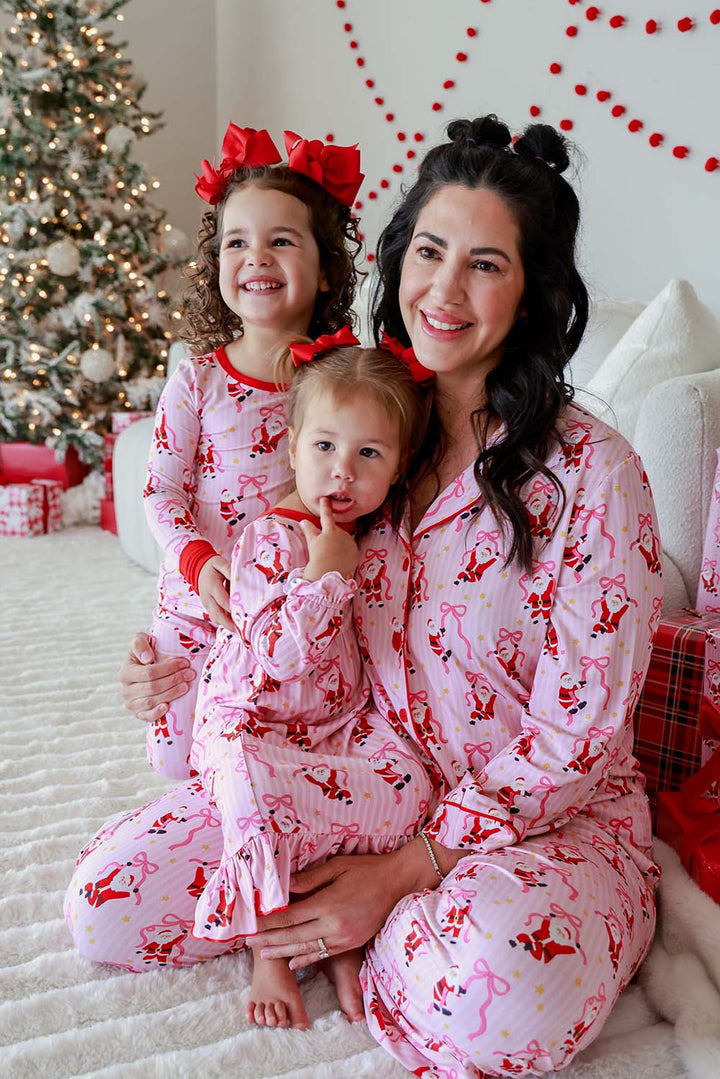 Mom and daughters wearing matching Caden Lane Jolly Ribbons Christmas pajamas for festive family photos and Christmas morning memories.