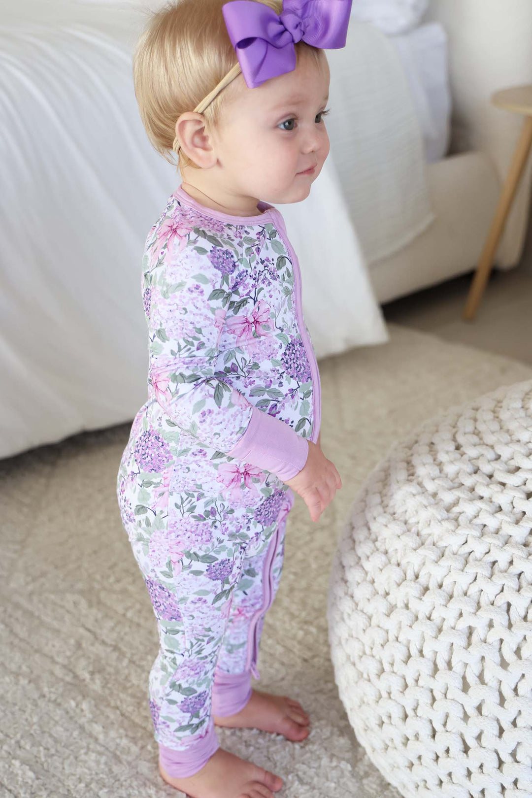 standing baby girl in lavender lullaby convertible zip romper