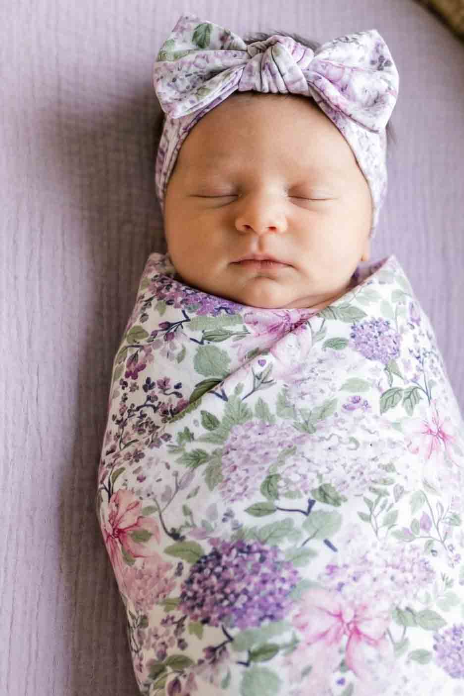 closeup of lavender lullaby swaddle blanket with matching headwrap 