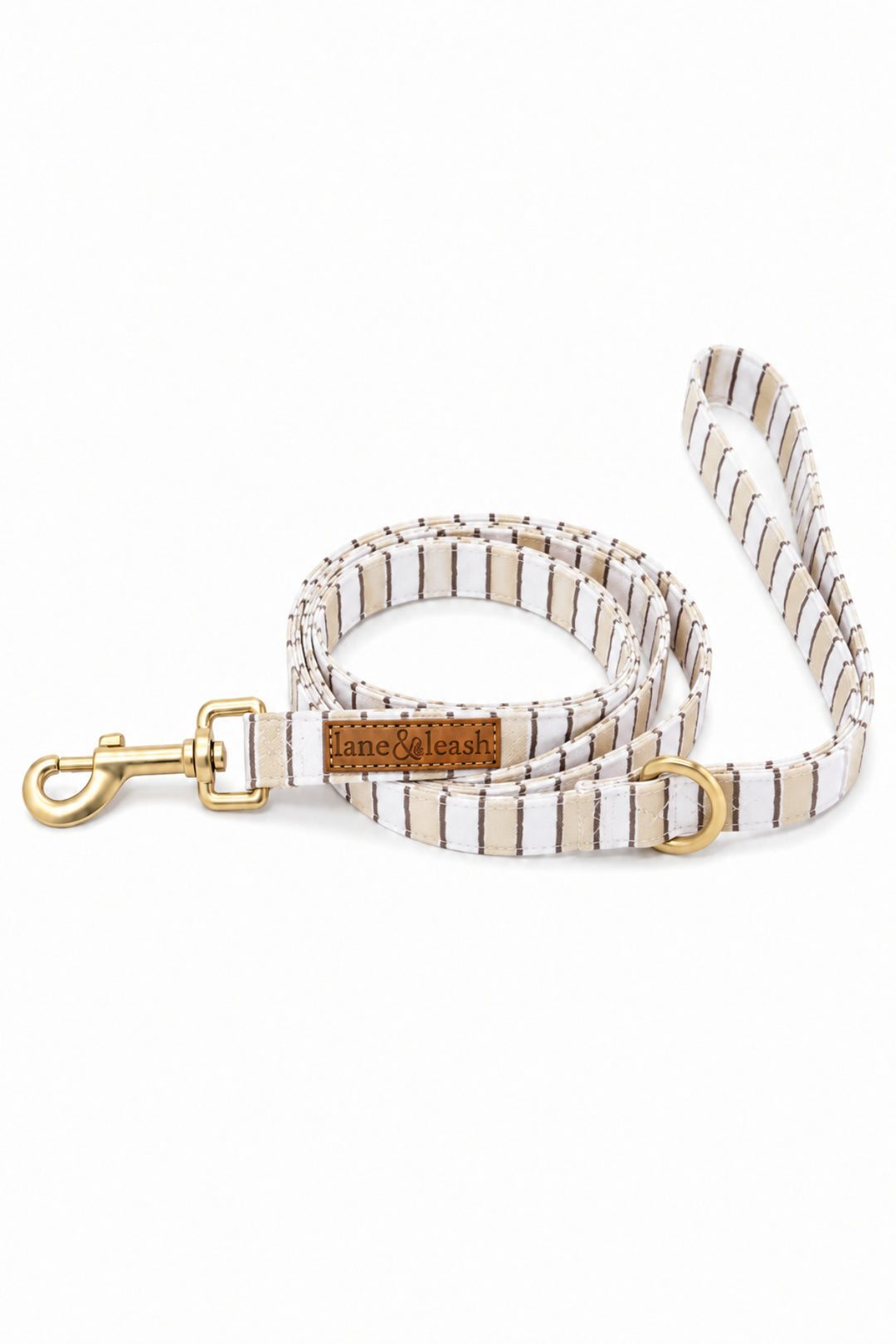 Heavy-duty dog leash in Biscuit Stripe pattern coiled to show full length, with a gold-tone swivel bolt snap clasp and a leather brand tag