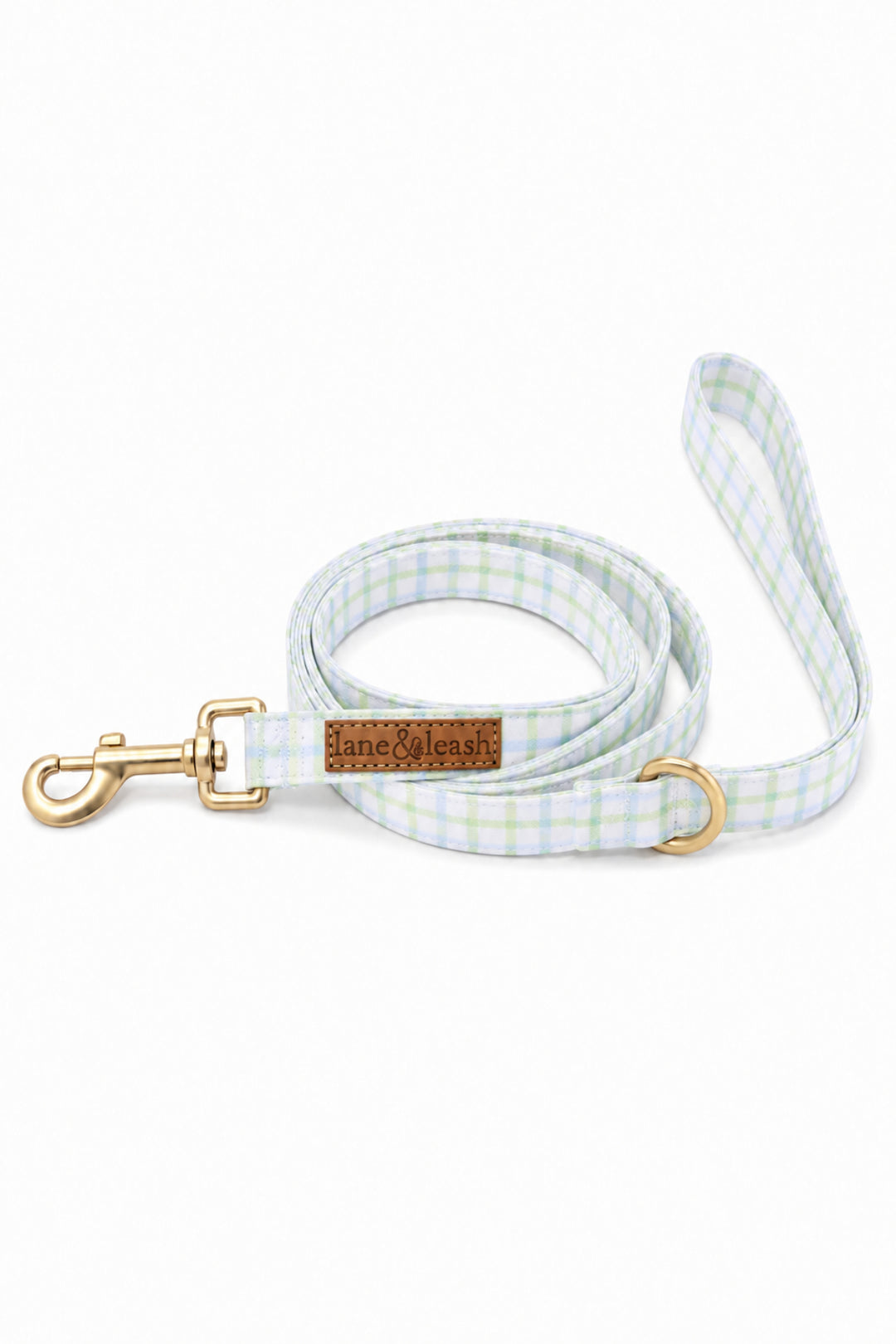 Heavy-duty dog leash in green and blue picnic plaid, coiled and showing the gold swivel clasp, D-ring, and Lane & Leash leather label