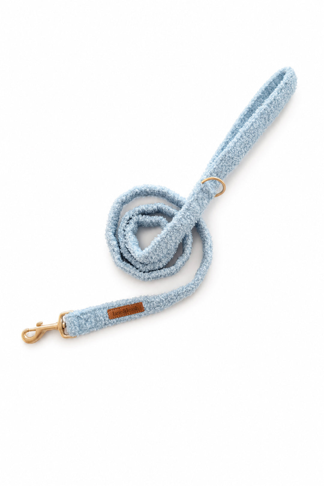 A light blue Lane & Leash textured fleece dog leash with gold-tone hardware, including a snap hook clasp and a metal ring, shown on a plain white background.