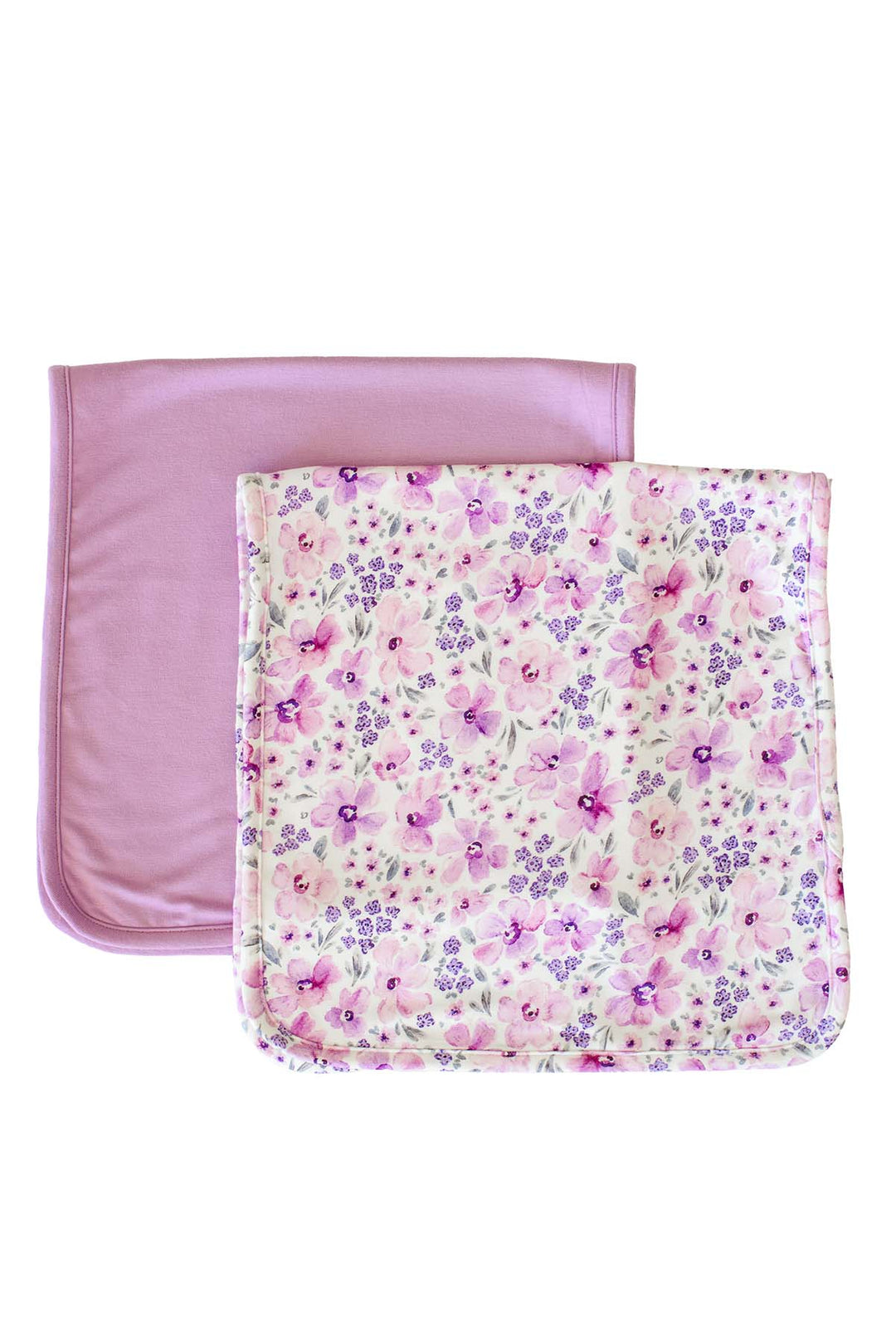 Flat lay of a Caden Lane white knit burp cloth in a Lilac Dreams print featuring pink watercolor blooms and tiny purple florals, paired with a solid lilac burp cloth.