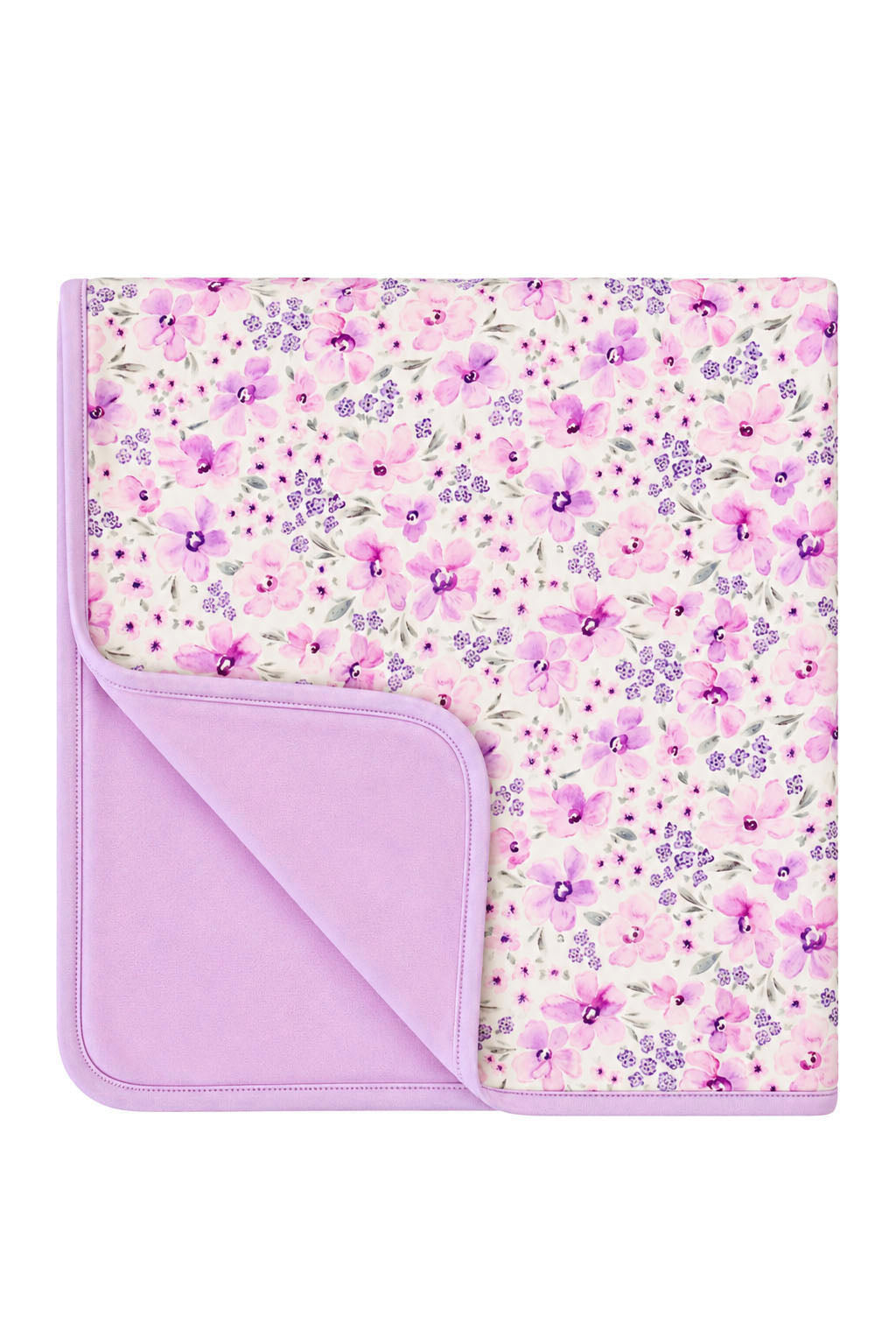 Flat lay of a folded Caden Lane cream knit blanket in a Lilac Dreams print featuring watercolor flowers, with one corner turned back to show a lilac reverse.