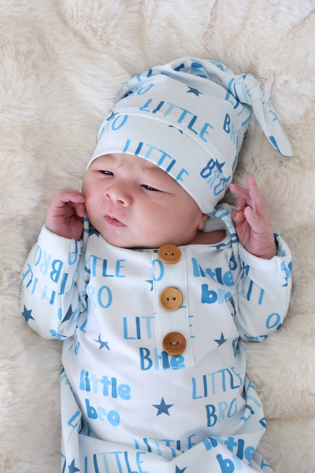 closeup of little bro newborn knot gown and hat set with brown buttons 