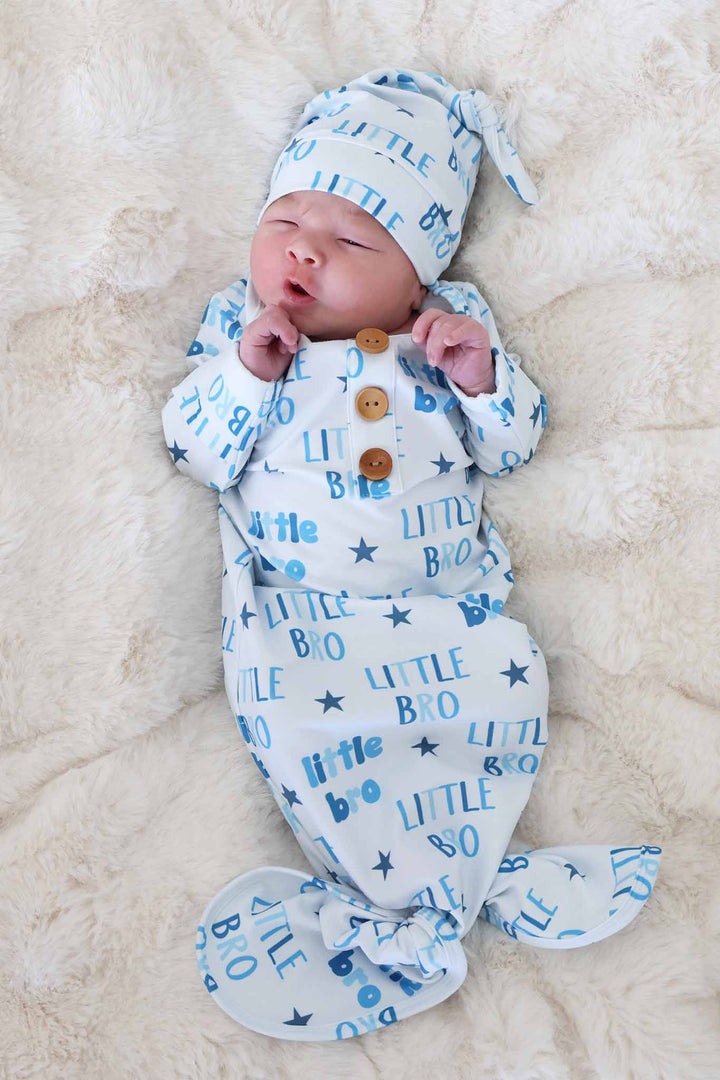 newborn boy in blue little bro star knot gown and hat set