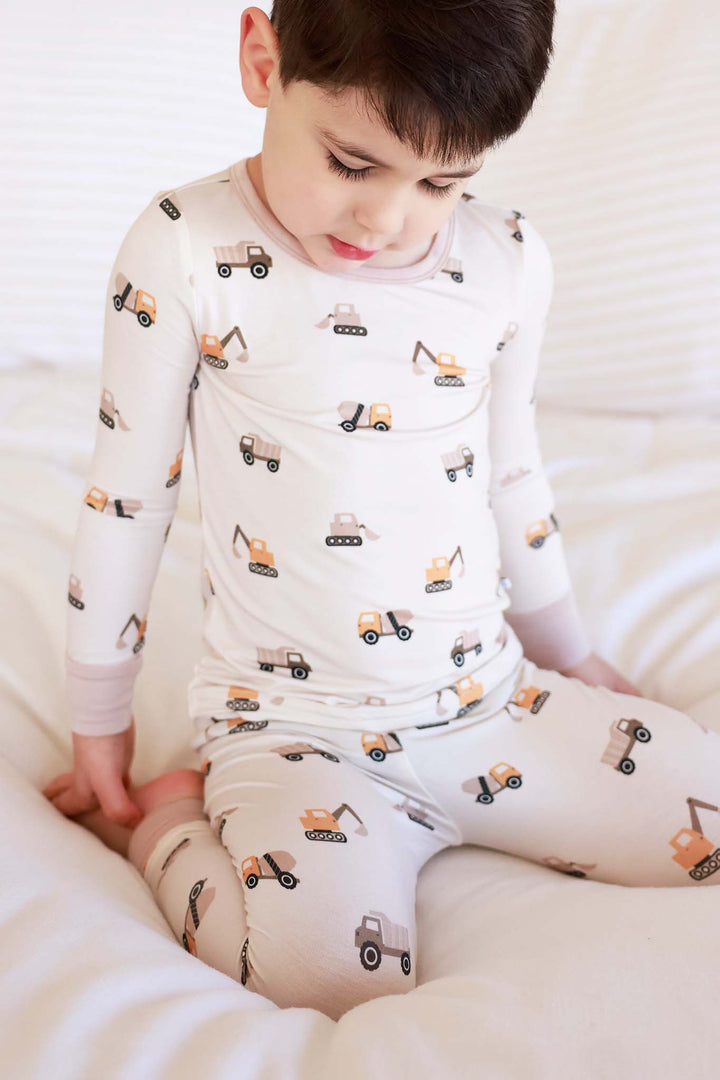 boy kneeling down wearing little builder two piece pajama set made of bamboo 