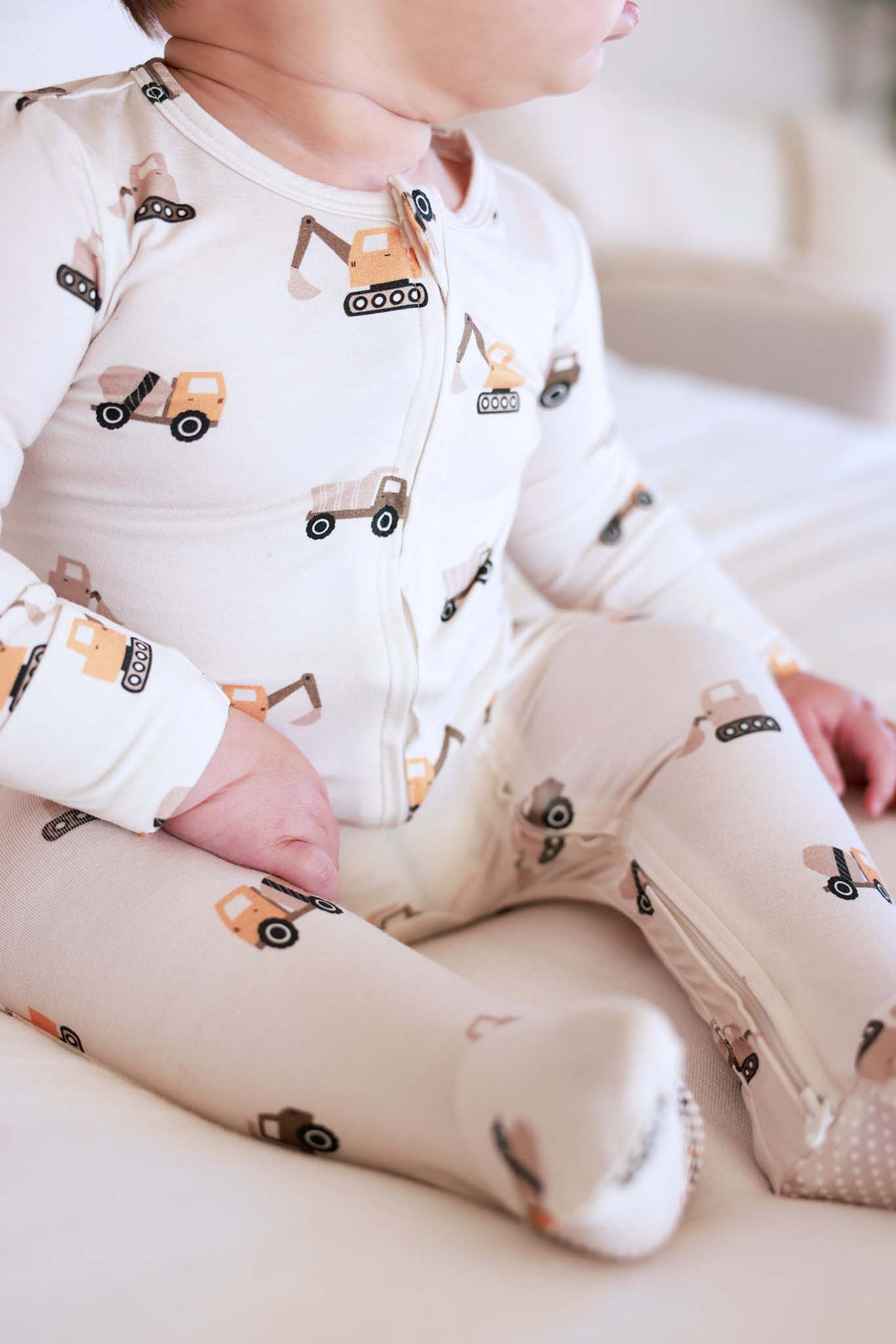 closeup of little builder zipper footie 