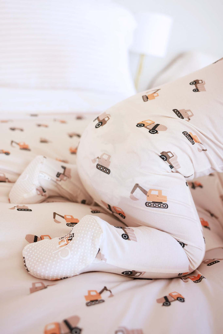 crawling baby wearing the little builder bamboo zipper footie