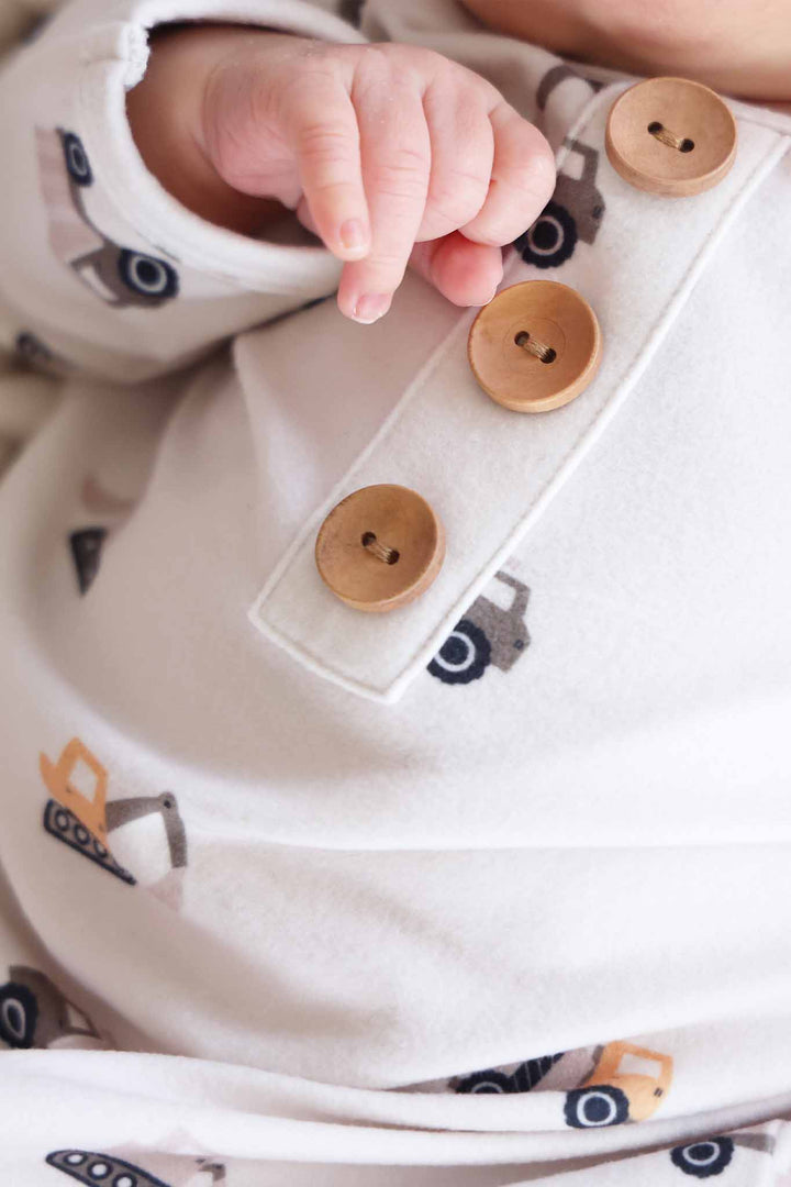 closeup of wooden buttons on little builder newborn knot gown 