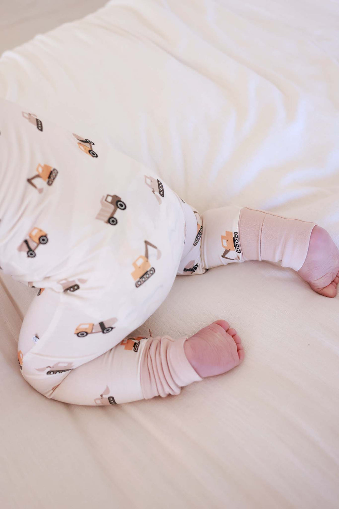 top view of baby crawling in little builder convertible zip romper 