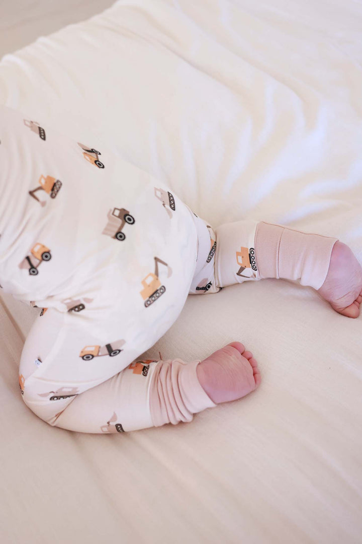 top view of baby crawling in little builder convertible zip romper 