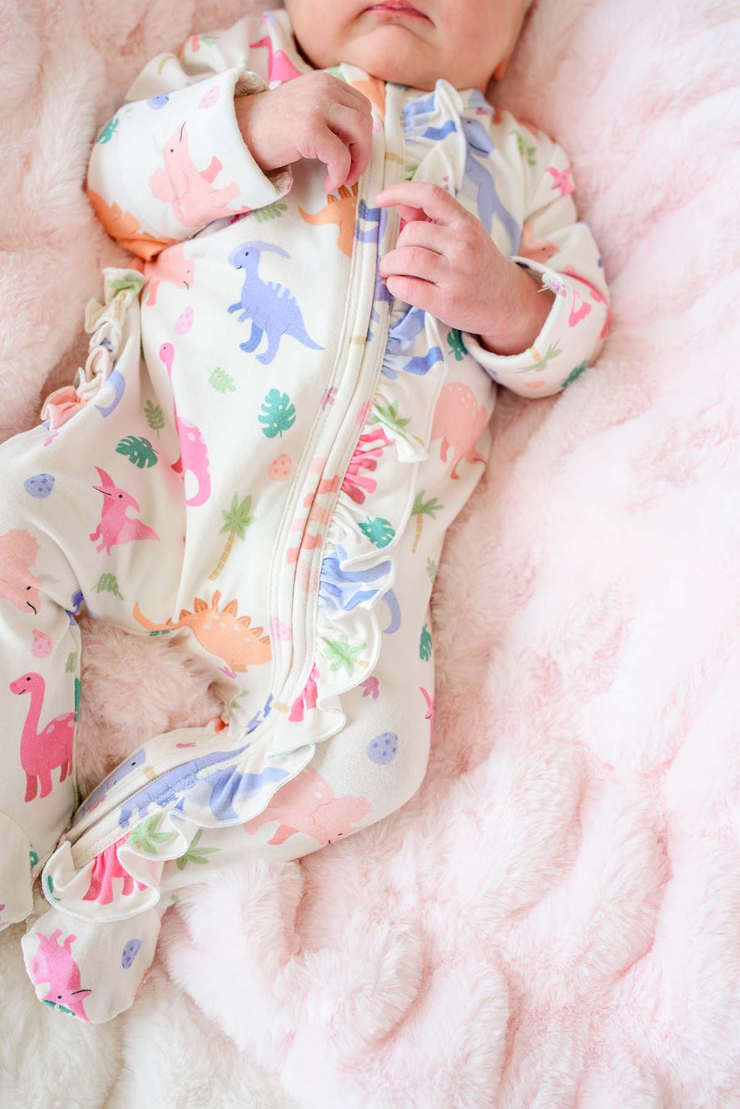 closeup of pink little fossil ruffle zipper footie 