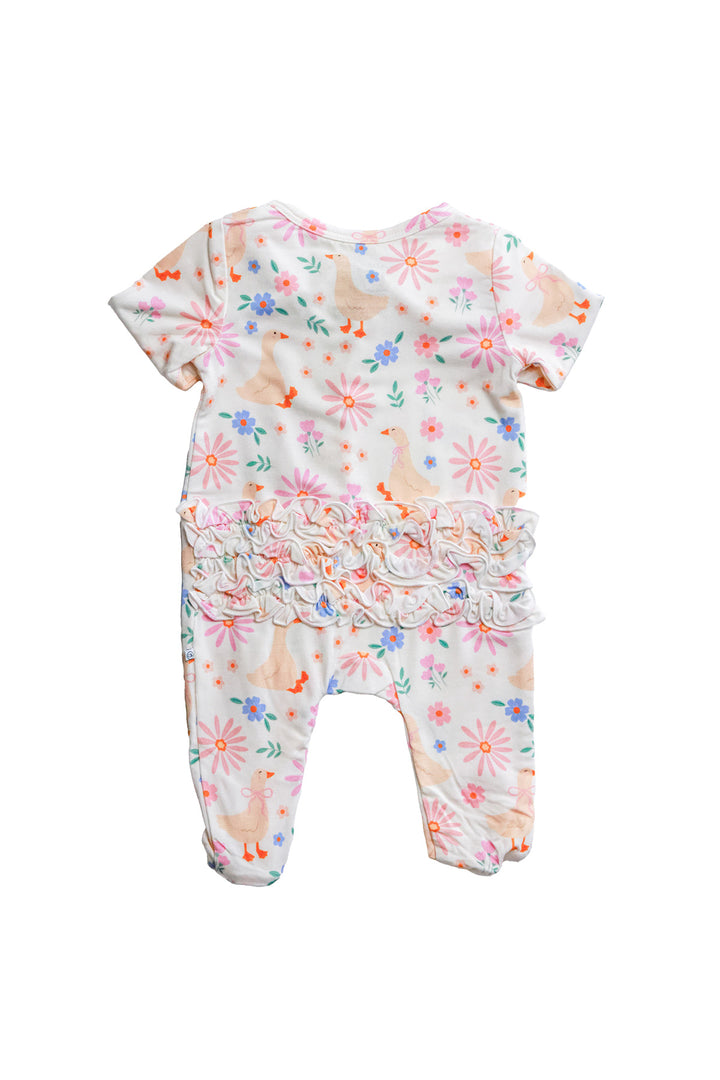 Lucy Goosy Ruffle Zipper Footie product flat lay back view showing the ruffle waistline detail and footed legs in the floral duck print on a white background