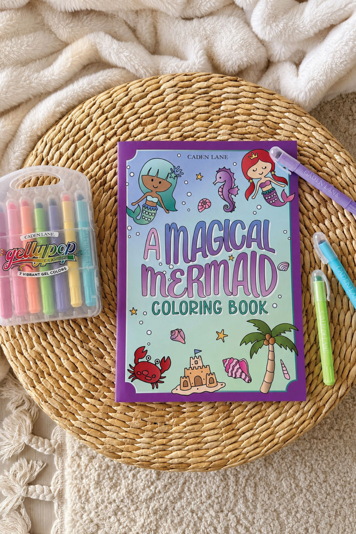 Caden Lane "A Magical Mermaid" coloring book styled with Gellypop gel crayons on a woven tray.