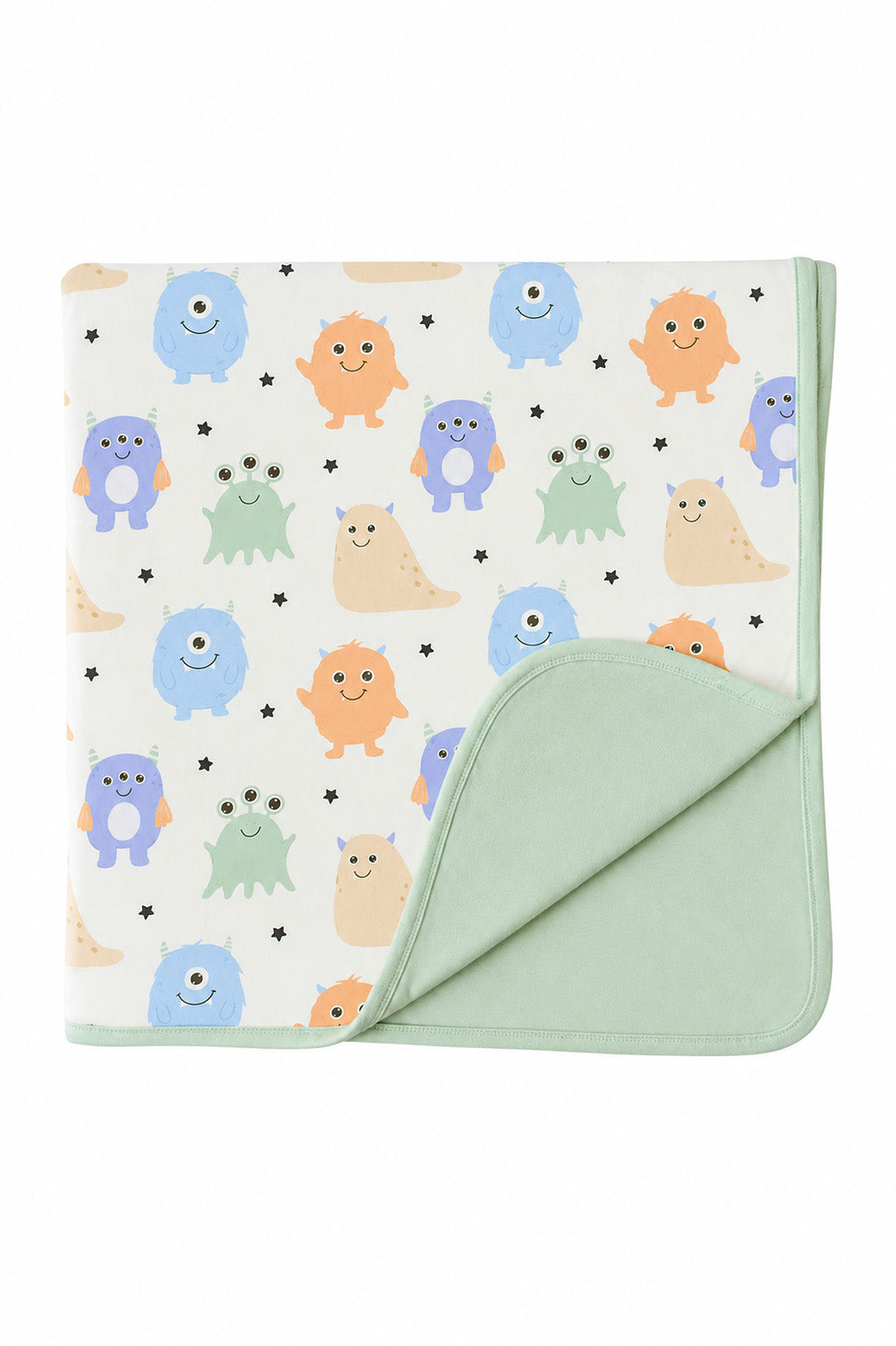 Flat lay of a Caden Lane Little Monsters bamboo blanket, folded to show cream monster print front and sage green reverse side
