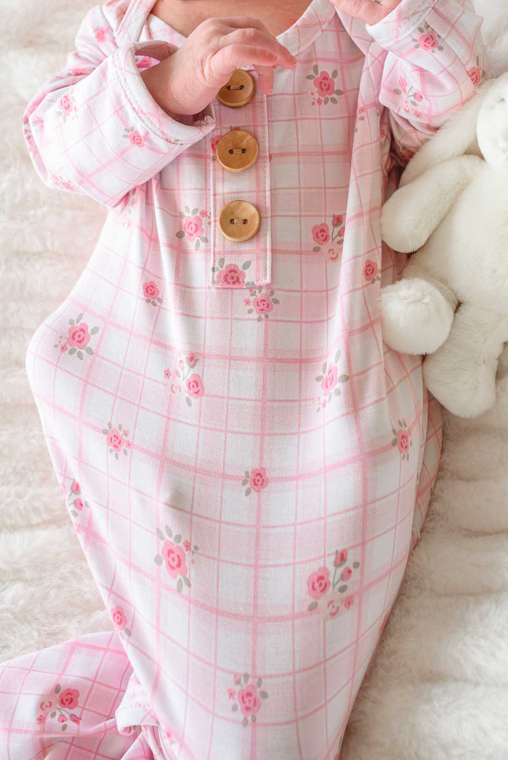 Close-up of wooden button and floral plaid fabric detail on knot gown