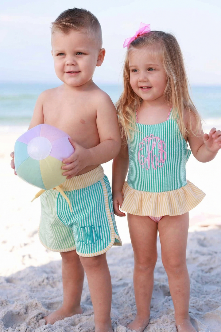 Little boy wearing the Multi-Color Seersucker shorts & little girl wearing matching Multi-Color Seersucker One-Piece Skirt with Bow Back
