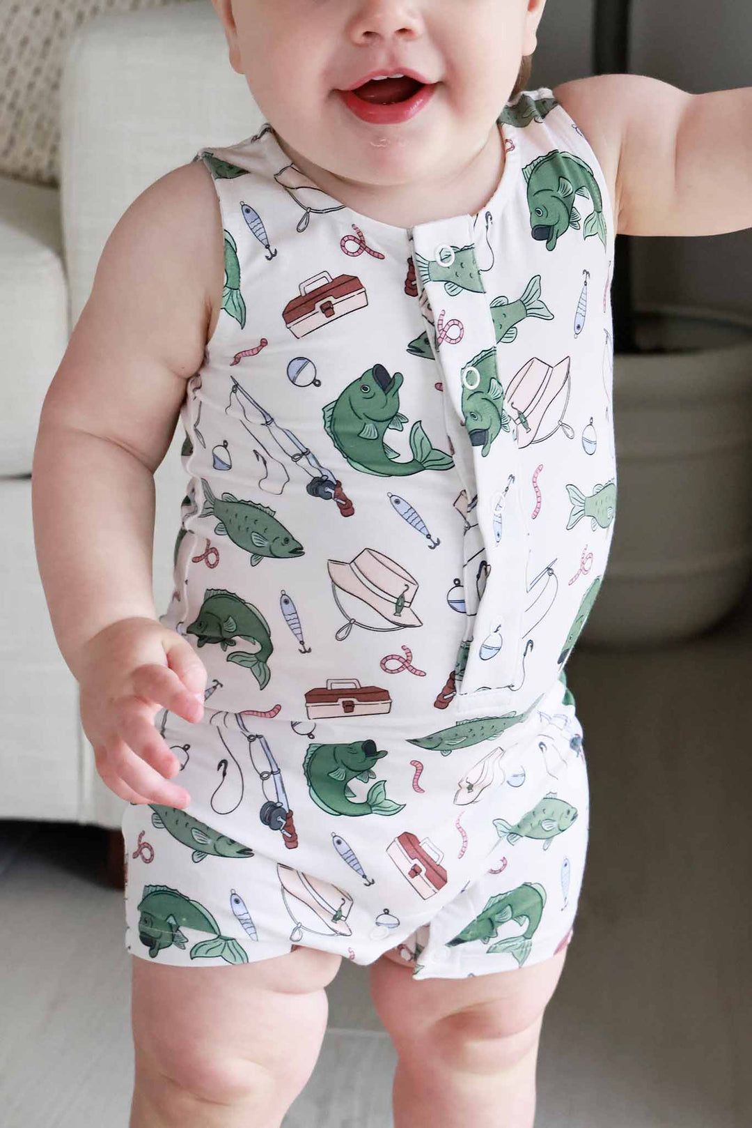 Close-up of baby wearing the Off The Hook sleeveless snap romper showing fishing print pattern detail