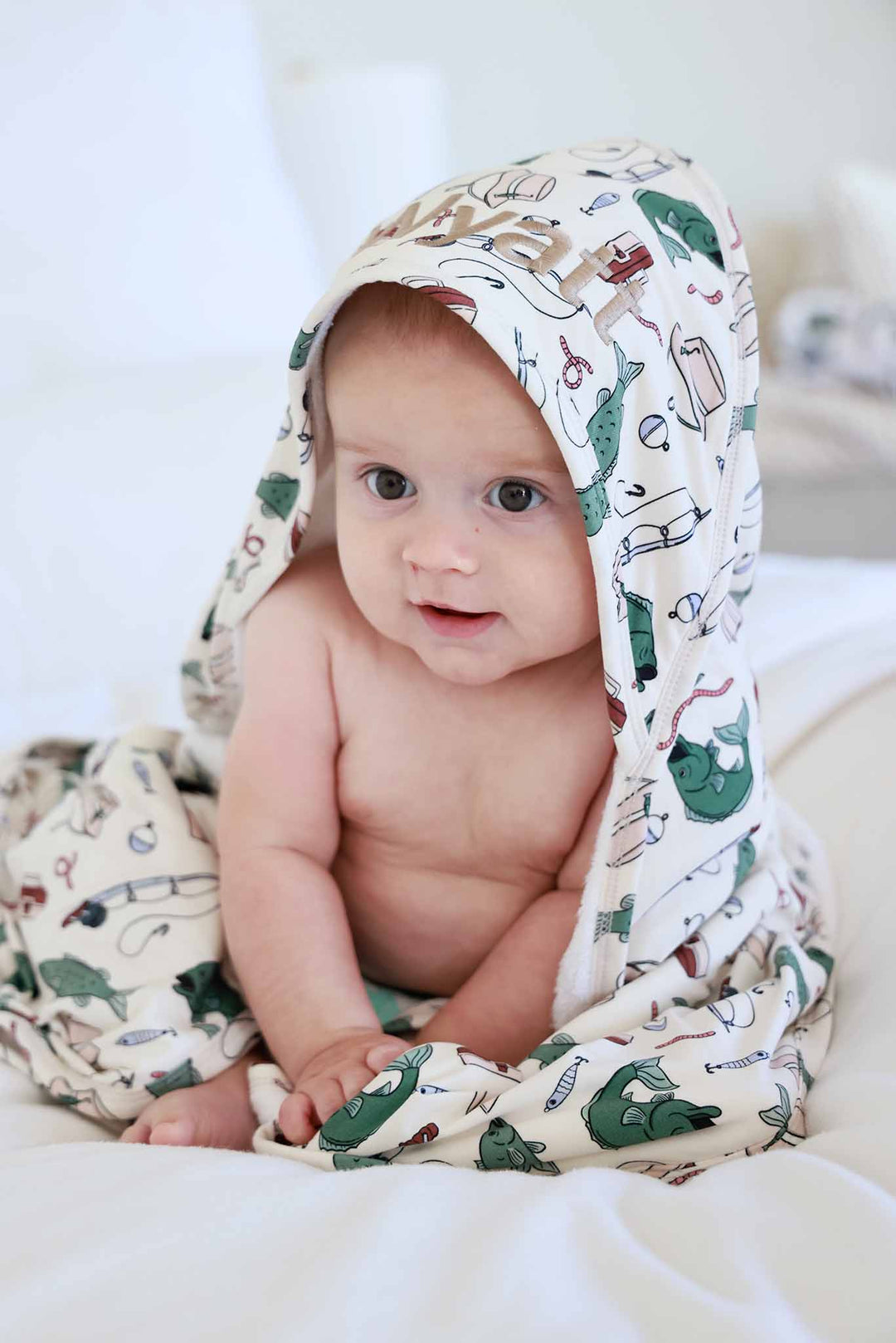 baby boy wrapped in fishing themed embroidered hooded towel
