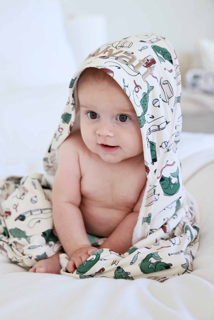 baby boy wrapped in fishing themed embroidered hooded towel