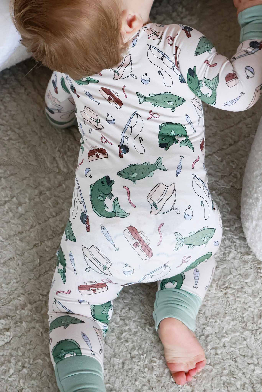 Back view of baby crawling showing the back of the Off The Hook convertible zip romper with fishing print