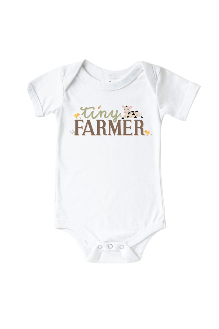 Caden Lane baby onesie with 'Tiny Farmer' graphic featuring calf and chicks