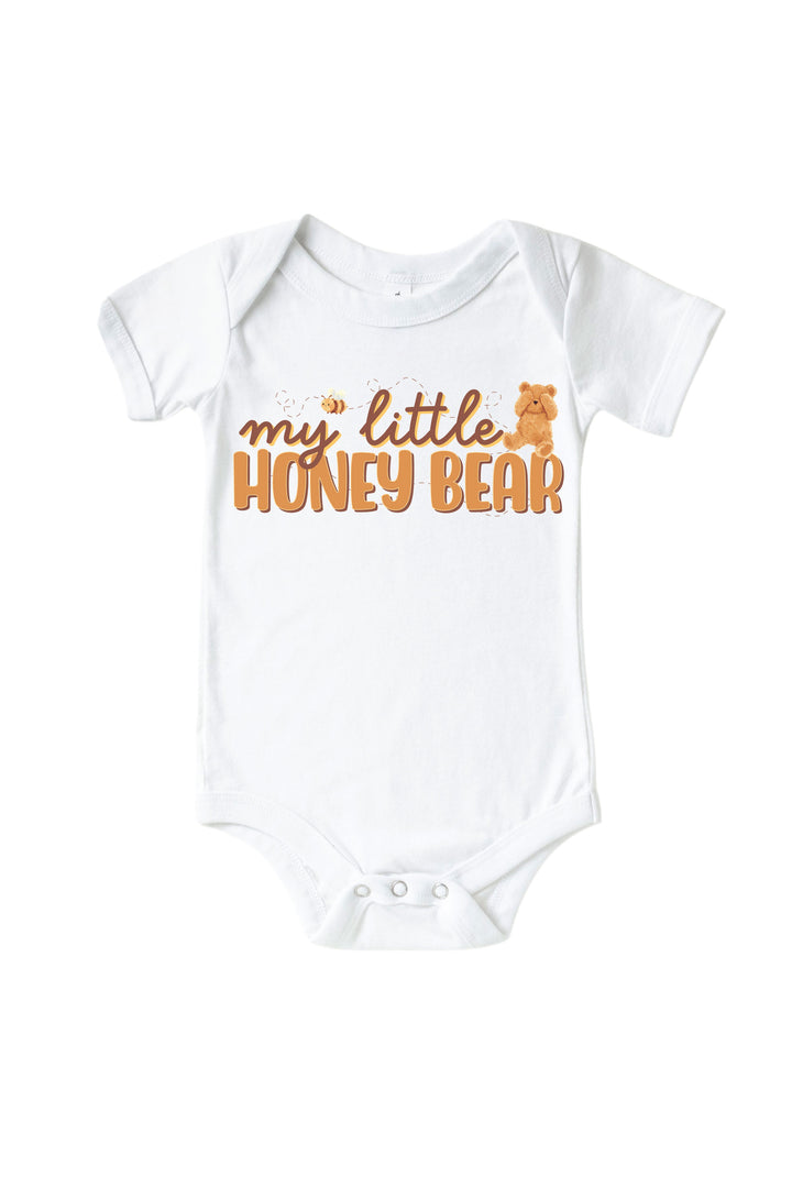 White baby onesie printed with 'my little honey bear' text, a teddy bear graphic, and a bee, laid flat on a white background