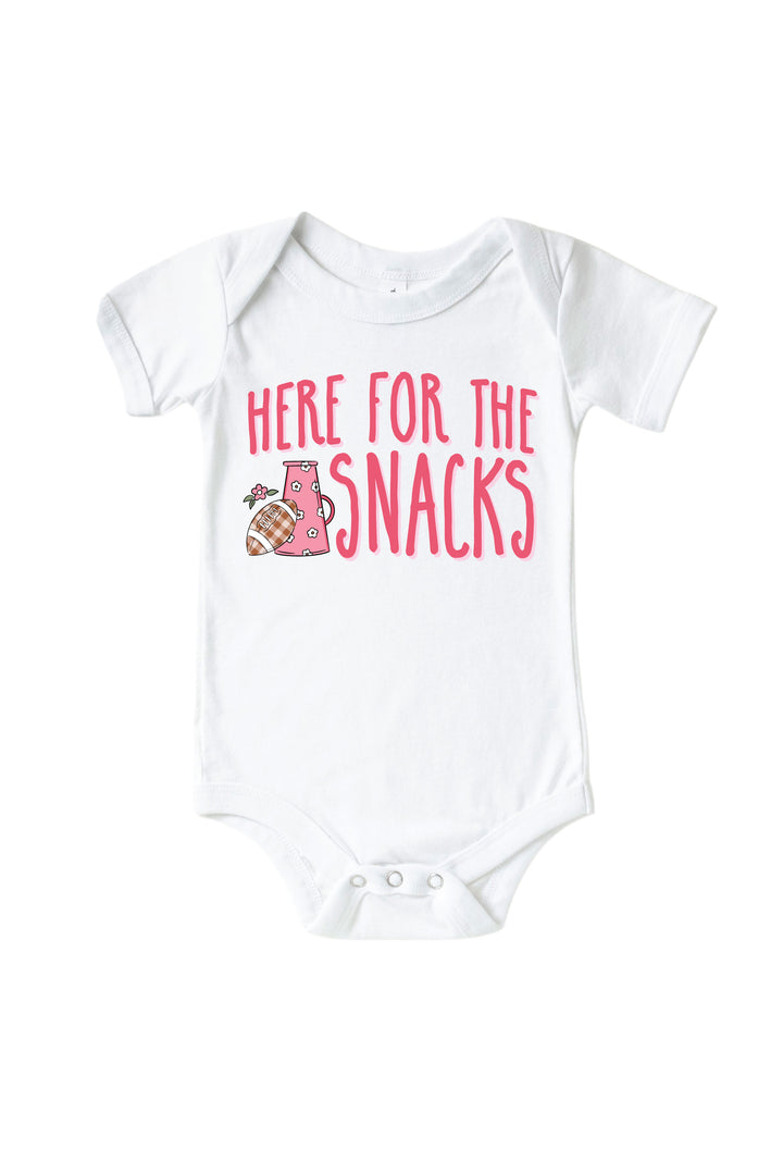 Caden Lane Graphic Bodysuit & Kids' Tee | Here for the Snacks Pink — baby bodysuit in white with "Here for the Snacks" graphic, featuring a floral megaphone and plaid football design.