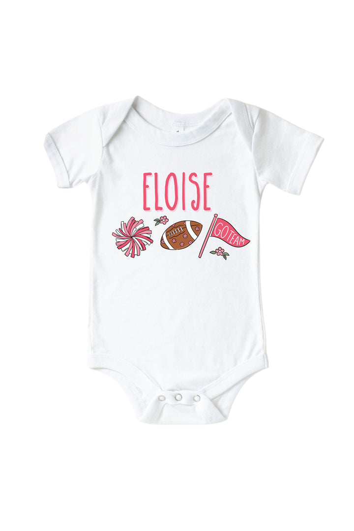 Caden Lane Personalized Graphic Bodysuit & Kids' Tee, Pink — baby bodysuit in white with custom name "Eloise" and a cheerleading graphic featuring a pom pom, floral football, and "Go Team" flag