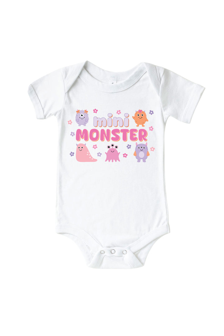 Caden Lane white baby onesie with "Mini Monster" graphic in purple and pink lettering, featuring pink, purple, and orange cartoon monsters and flowers