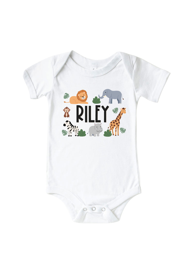 Caden Lane personalized white baby bodysuit with the name "Riley" surrounded by safari animal illustrations — lion, elephant, monkey, zebra, hippo, and giraffe.