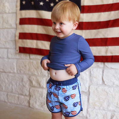 red, white and blue swim trunks for kids with sunglasses 
